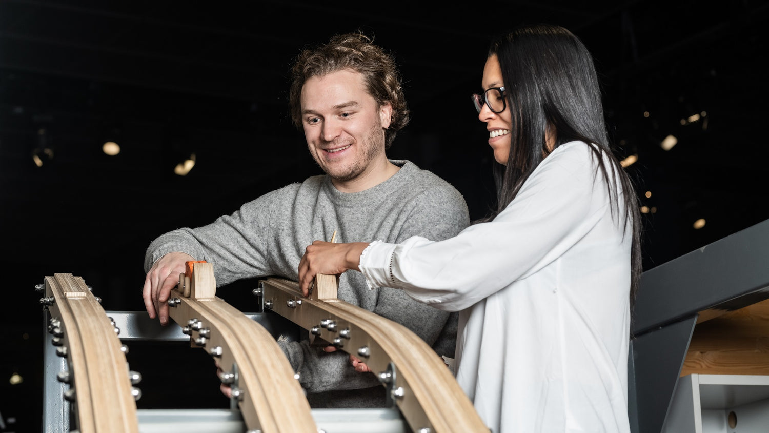 At Heureka's Idea Workshop two adults at the mountain car track.