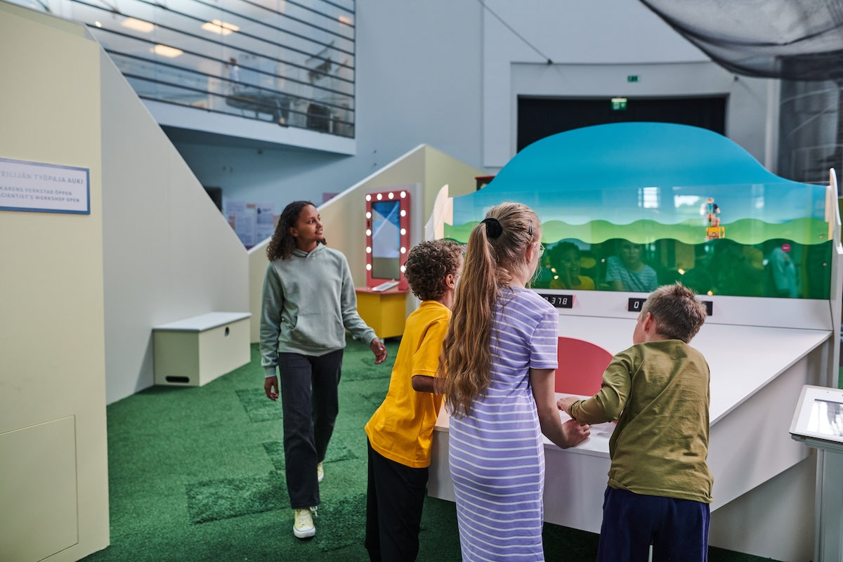 Four children at an artificial intelligence exhibition.