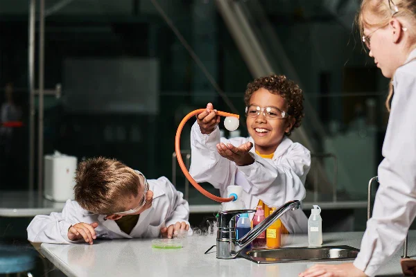 Children in a laboratory with happy expressions on their faces.