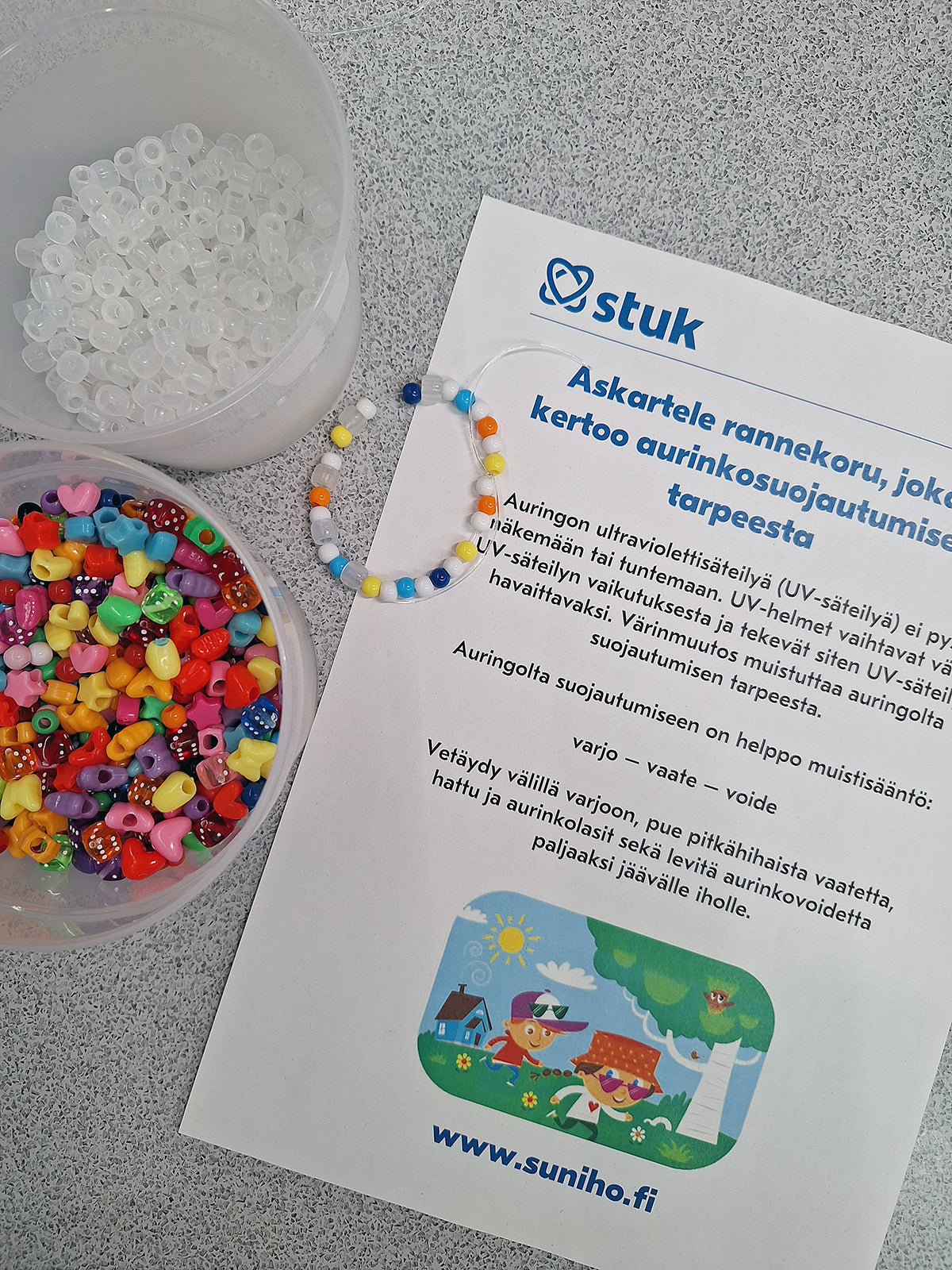 Helmiä ja rannekoru pöydällä.